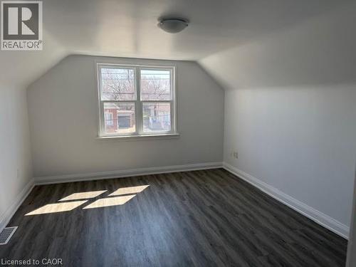 Additional living space featuring dark wood-style floors and baseboards - 322 Upper Gage Avenue, Hamilton, ON - Indoor Photo Showing Other Room