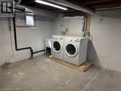 Laundry area featuring unfinished concrete flooring and independent washer and dryer - 322 Upper Gage Avenue, Hamilton, ON - Indoor Photo Showing Laundry Room