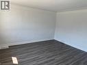 Unfurnished room featuring dark wood-style flooring and baseboards - 322 Upper Gage Avenue, Hamilton, ON  - Indoor Photo Showing Other Room 