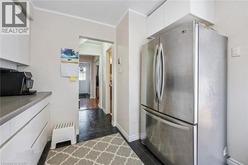 Kitchen with white cabinetry, freestanding refrigerator, crown molding, and light countertops - 55 Ralgreen Crescent, Kitchener, ON - Indoor Photo Showing Kitchen