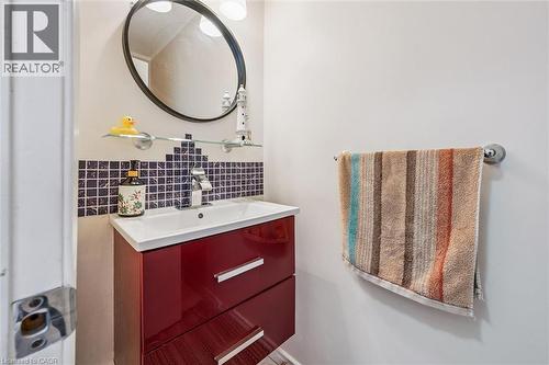 Half bath featuring vanity and tile walls - 55 Ralgreen Crescent, Kitchener, ON - Indoor Photo Showing Bathroom