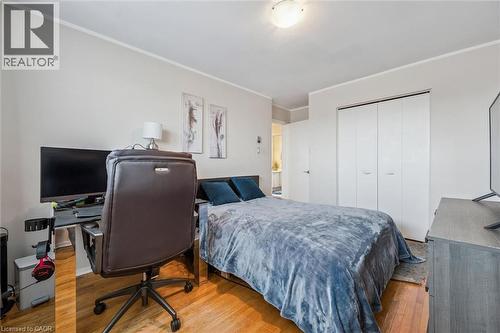Bedroom featuring crown molding, an office area, a closet, and light wood-style flooring - 55 Ralgreen Crescent, Kitchener, ON - Indoor Photo Showing Bedroom
