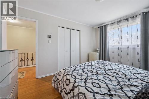 Bedroom featuring light wood-style floors, a closet, and crown molding - 55 Ralgreen Crescent, Kitchener, ON - Indoor Photo Showing Bedroom