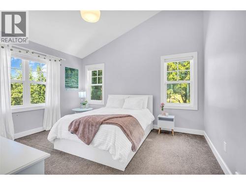 Main level bedroom with ensuite and large walk in closet - 2376 Saucier Road, Kelowna, BC - Indoor Photo Showing Bedroom
