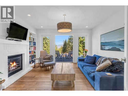 Easy access to your outdoor paradise - 2376 Saucier Road, Kelowna, BC - Indoor Photo Showing Living Room With Fireplace