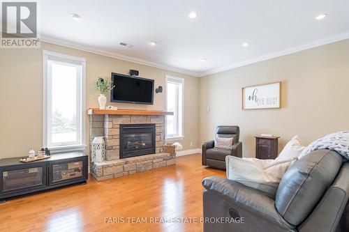 130 Concession 15 W, Tiny, ON - Indoor Photo Showing Living Room With Fireplace