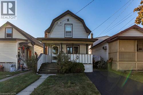 Colonial inspired home featuring a gambrel roof, covered porch, and a front lawn - 23 Frederick Avenue, Hamilton, ON - Outdoor With Deck Patio Veranda