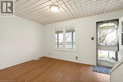 Entryway featuring dark wood-style flooring and baseboards - 