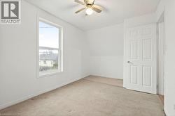 Unfurnished room with ceiling fan, light colored carpet, and vaulted ceiling - 