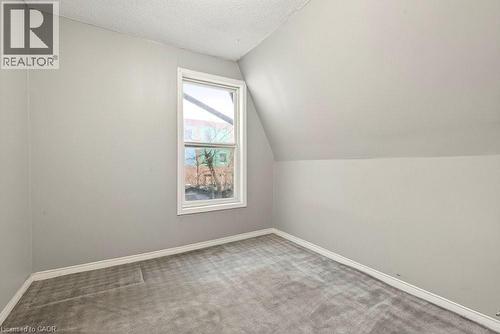 Bonus room with carpet floors and baseboards - 23 Frederick Avenue, Hamilton, ON - Indoor Photo Showing Other Room