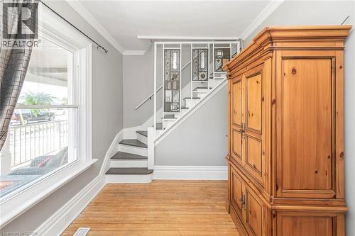 Stairway with crown molding and wood-type flooring - 120 Caithness Street E, Caledonia, ON - Indoor Photo Showing Other Room