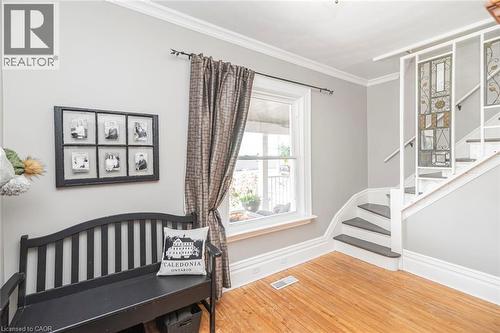 Bedroom with light wood-style floors and ornamental molding - 120 Caithness Street E, Caledonia, ON - Indoor