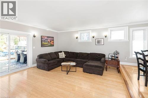Living area with healthy amount of natural light, crown molding, and light wood-style floors - 120 Caithness Street E, Caledonia, ON - Indoor Photo Showing Living Room