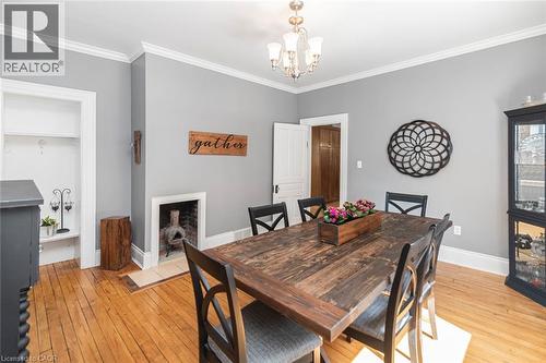 Dining space with crown molding, light wood-style flooring, and a chandelier - 120 Caithness Street E, Caledonia, ON - Indoor Photo Showing Dining Room