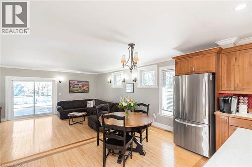 Dining area with crown molding, light wood finished floors, and hanging lights - 120 Caithness Street E, Caledonia, ON - Indoor Photo Showing Other Room