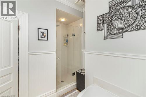 Full bathroom featuring a wainscoted wall, crown molding, a stall shower, and a garden tub - 120 Caithness Street E, Caledonia, ON - Indoor Photo Showing Bathroom
