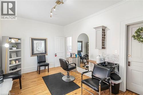 Office space featuring arched walkways, light wood-type flooring, crown molding, and track lighting - 120 Caithness Street E, Caledonia, ON - Indoor