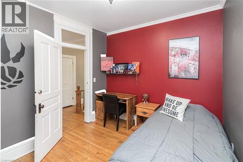 Bedroom with light wood-type flooring, an office area, and crown molding - 120 Caithness Street E, Caledonia, ON - Indoor Photo Showing Bedroom