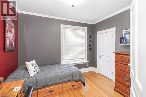 Bedroom with ornamental molding and light wood-style floors - 120 Caithness Street E, Caledonia, ON - Indoor Photo Showing Bedroom