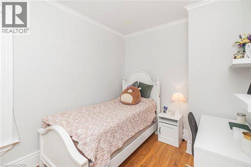 Bedroom with ornamental molding and light wood-style flooring - 120 Caithness Street E, Caledonia, ON - Indoor Photo Showing Bedroom