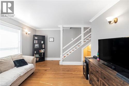 Living room with crown molding and light wood-style floors - 120 Caithness Street E, Caledonia, ON - Indoor Photo Showing Living Room