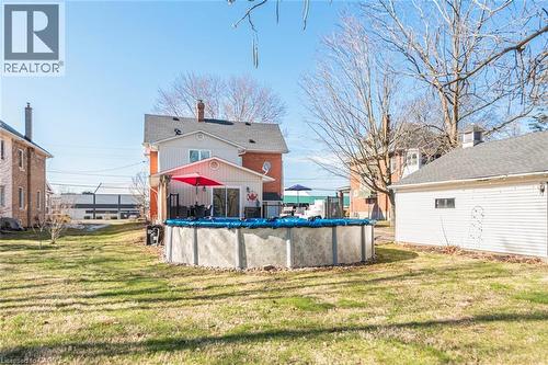 Back of property featuring a yard and a covered pool - 120 Caithness Street E, Caledonia, ON - Outdoor With Above Ground Pool