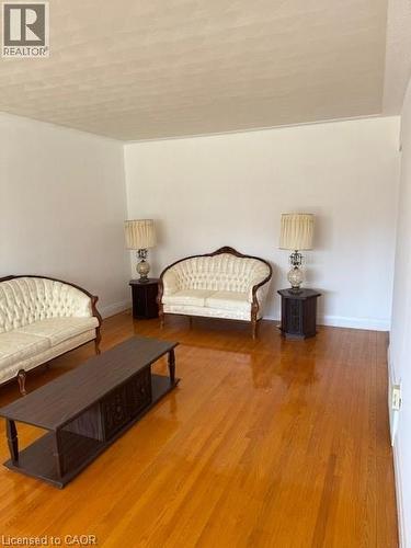 Sitting room with wood finished floors and baseboards - 31 Adair Avenue, Hamilton, ON - Indoor
