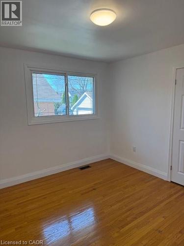 Empty room featuring baseboards and hardwood / wood-style floors - 31 Adair Avenue, Hamilton, ON - Indoor Photo Showing Other Room