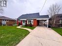 The property features a red brick exterior, a paved driveway, and a front yard with a walkway - 122 Weber Street S, Waterloo, ON  - Outdoor 