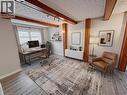 Office space featuring beamed ceiling, a textured ceiling, and light wood-type flooring. Main floor. Virtually staged. - 122 Weber Street S, Waterloo, ON  - Indoor 