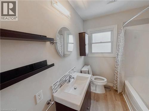Bathroom with vanity, shower / bath combo with shower curtain, and light wood finished floors - 122 Weber Street S, Waterloo, ON - Indoor Photo Showing Bathroom