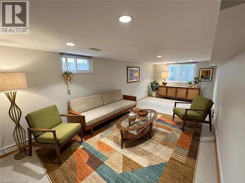 Living room with healthy amount of natural light, recessed lighting, and baseboard heating. Basement. Virtually staged. - 122 Weber Street S, Waterloo, ON - Indoor Photo Showing Other Room