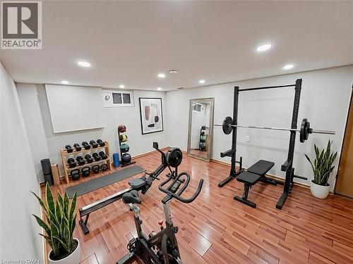 Exercise area with light wood-style floors and recessed lighting. Basement. Virtually staged. - 122 Weber Street S, Waterloo, ON - Indoor
