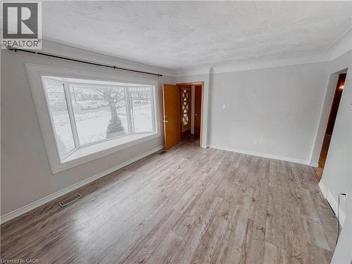 Empty room featuring baseboards and light wood finished floors - 122 Weber Street S, Waterloo, ON - Indoor Photo Showing Other Room
