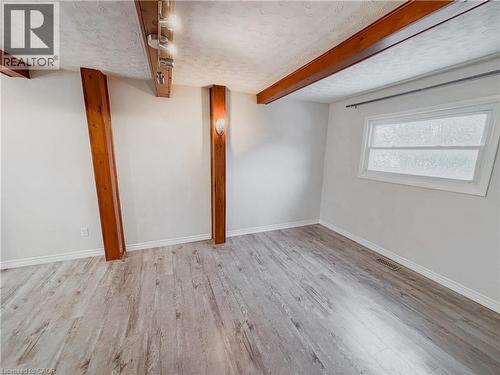 Basement with light wood-style flooring and a textured ceiling - 122 Weber Street S, Waterloo, ON - Indoor Photo Showing Other Room