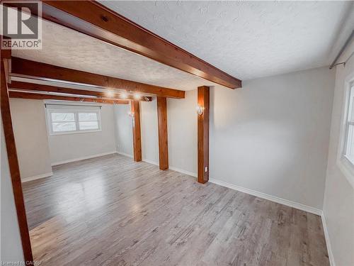 Basement with light wood finished floors and a textured ceiling - 122 Weber Street S, Waterloo, ON - Indoor