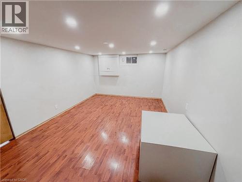 Finished below grade area with light wood finished floors and recessed lighting - 122 Weber Street S, Waterloo, ON - Indoor