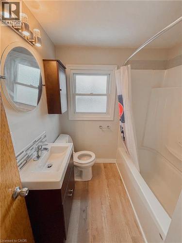 Bathroom with vanity, shower / bath combo, and light wood-type flooring - 122 Weber Street S, Waterloo, ON - Indoor Photo Showing Bathroom