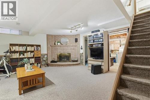 Basement Family Room featuring wood-burning fireplace. - 56 Rushbrook Drive, Kitchener, ON - Indoor With Fireplace