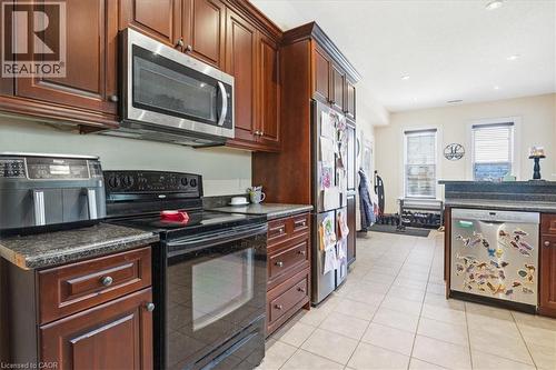 Cherry cabinets and stainless appliances - 31 Bingeman Street, Kitchener, ON - Indoor Photo Showing Kitchen