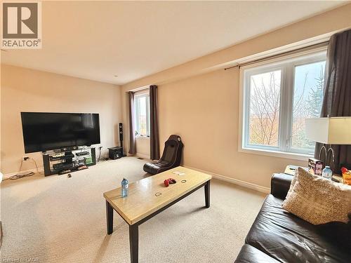 Carpeted living room with baseboards - 101 Robert Simone Way, Ayr, ON - Indoor Photo Showing Living Room