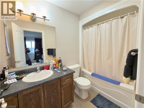 Bathroom with vanity, shower / bathtub combination with curtain, and light tile patterned flooring - 101 Robert Simone Way, Ayr, ON - Indoor Photo Showing Bathroom