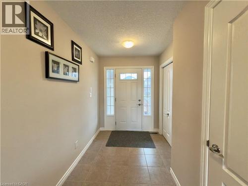 Entryway with a textured ceiling and light tile patterned flooring - 101 Robert Simone Way, Ayr, ON - Indoor Photo Showing Other Room