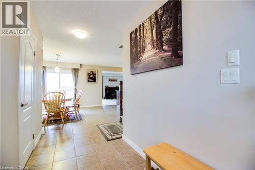 Corridor featuring light tile patterned floors and a textured ceiling - 101 Robert Simone Way, Ayr, ON - Indoor Photo Showing Other Room