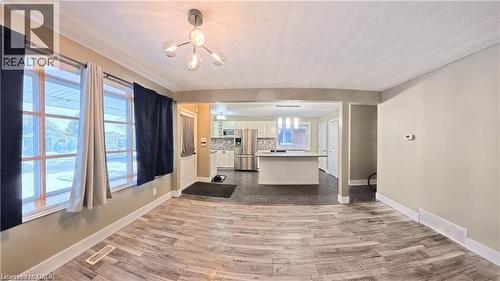 Living room featuring healthy amount of natural light and dark wood finished floors - 61 Bosworth Crescent Unit# Upper, Kitchener, ON - Indoor Photo Showing Other Room