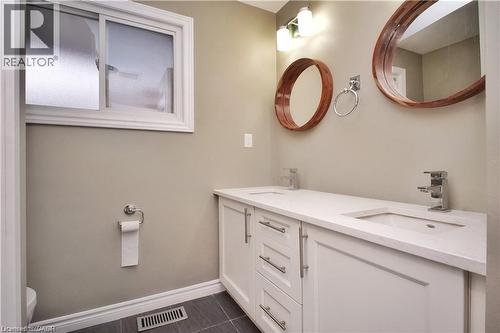 Full bathroom with double vanity and dark tile patterned floors - 61 Bosworth Crescent Unit# Upper, Kitchener, ON - Indoor Photo Showing Bathroom