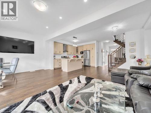 Living room with dark wood finished floors and recessed lighting - 30 Times Square Boulevard, Hamilton, ON - Indoor Photo Showing Living Room
