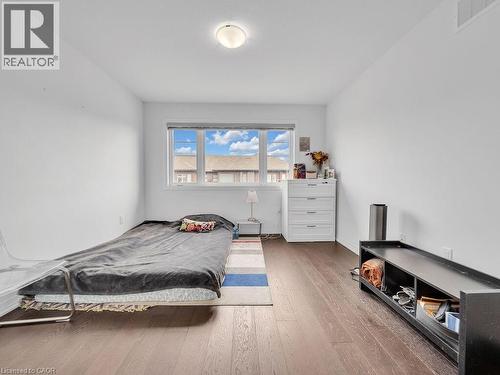 Bedroom with wood-type flooring and baseboards - 30 Times Square Boulevard, Hamilton, ON - Indoor Photo Showing Bedroom