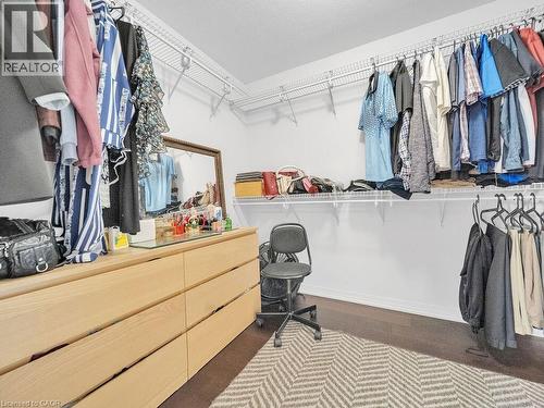 Walk in closet with wood finished floors - 30 Times Square Boulevard, Hamilton, ON - Indoor With Storage