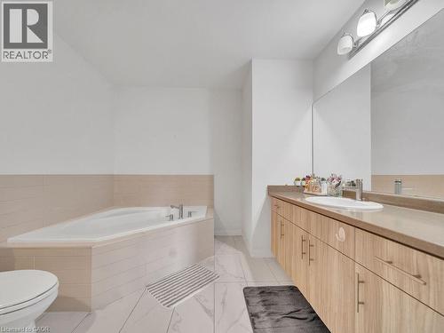 Bathroom with vanity and a bath - 30 Times Square Boulevard, Hamilton, ON - Indoor Photo Showing Bathroom